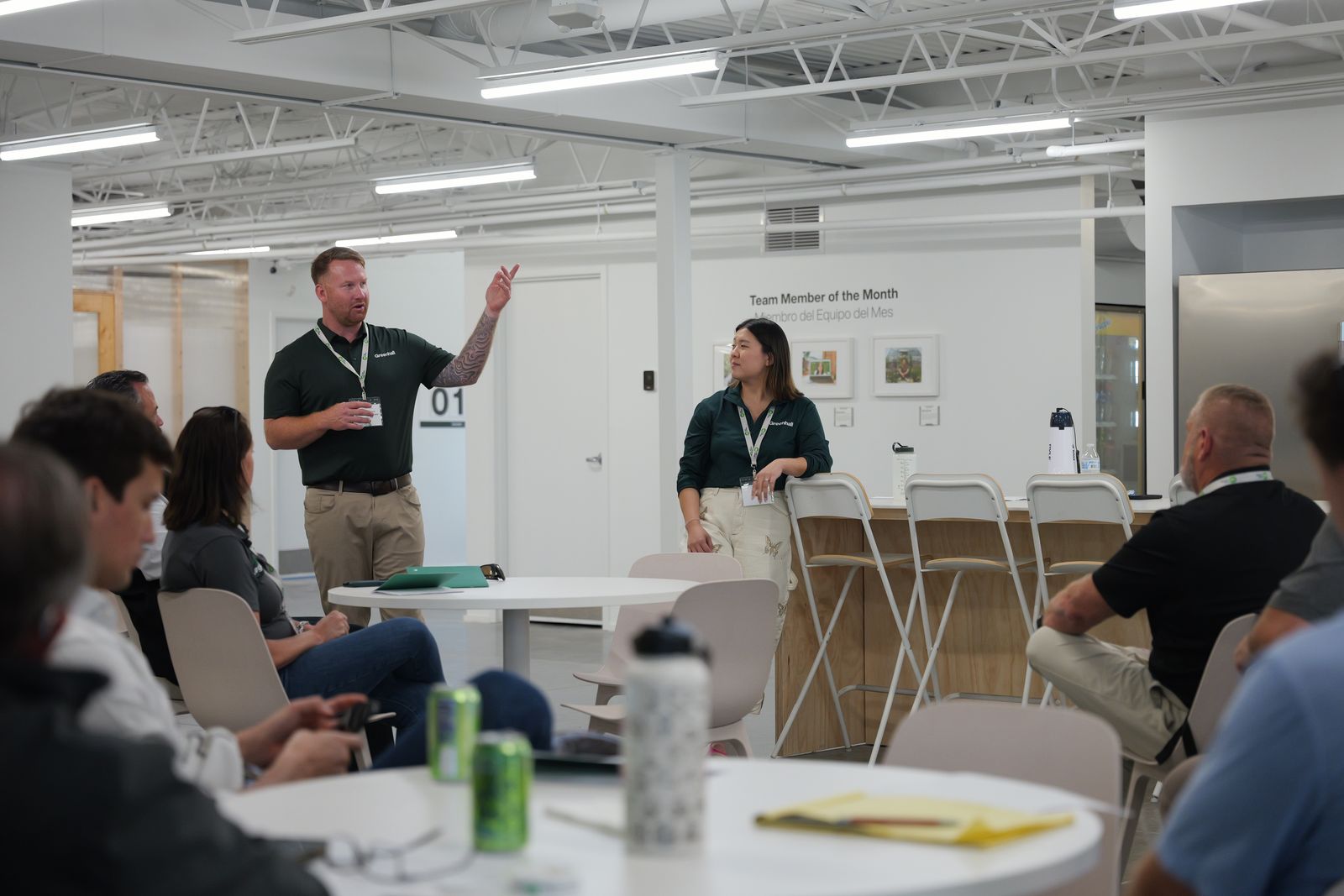 Greenhall leaders presenting in the team break room